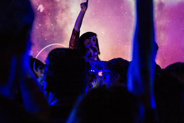 Singer Grace Castro with hand raised at Decks in the Park Halloween Edition in Klyde Warren Park on October 30th 2014 