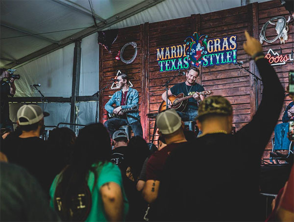 Mardi Gras Texas style Band playing to an concert goers.